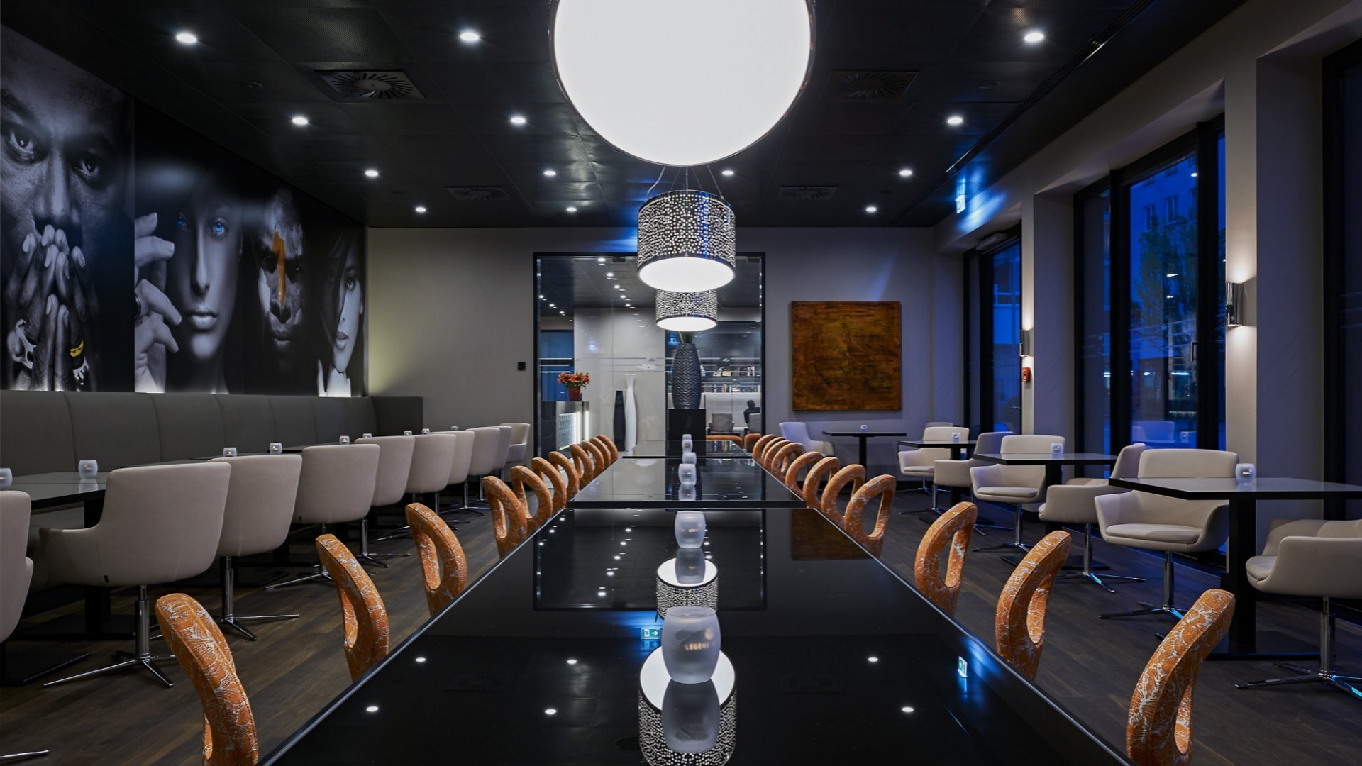 Stylish restaurant with black high-gloss tables and comfortable swivel chairs